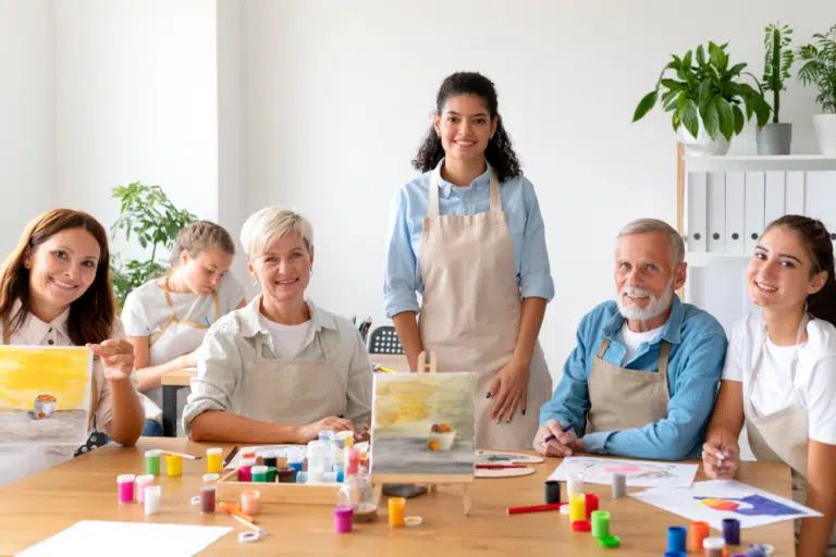 Residents and staff participating in a painting activity