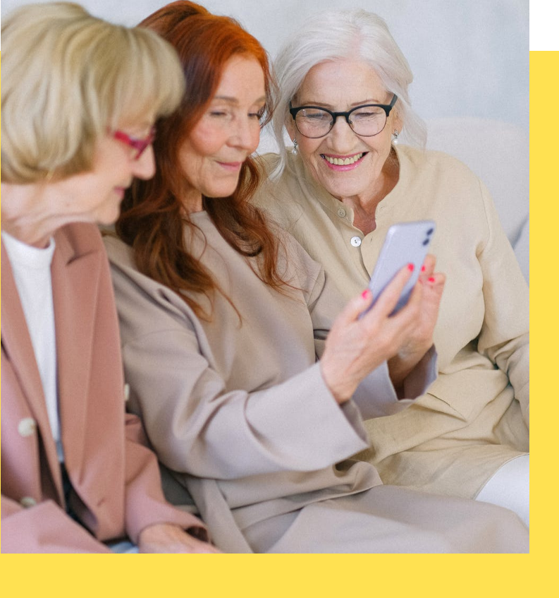 Three women enjoying a moment together in a common area