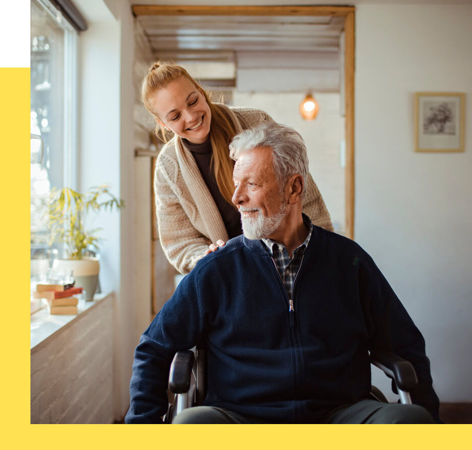 Caregiver assisting a resident in a cozy interior