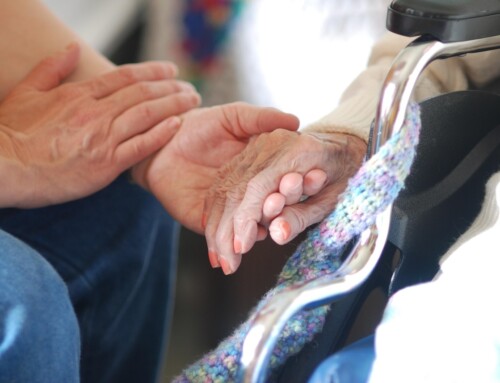 Two hands clasped together in a caring gesture