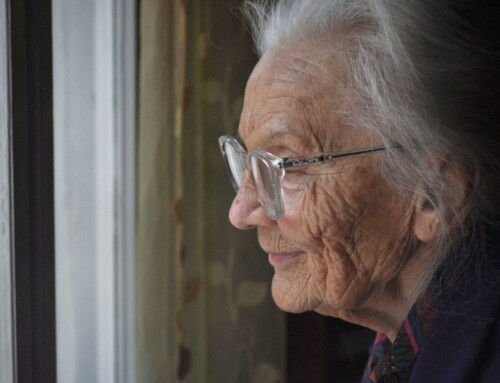 Elderly woman looking out the window