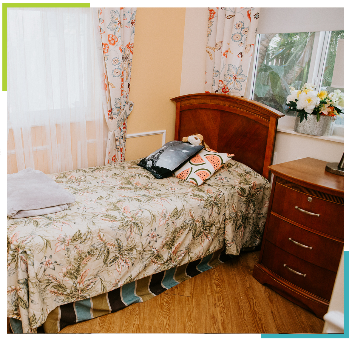Cozy resident room with floral bedding and decor
