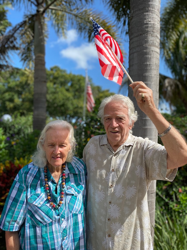 Residents celebrating with an American flag in a garden