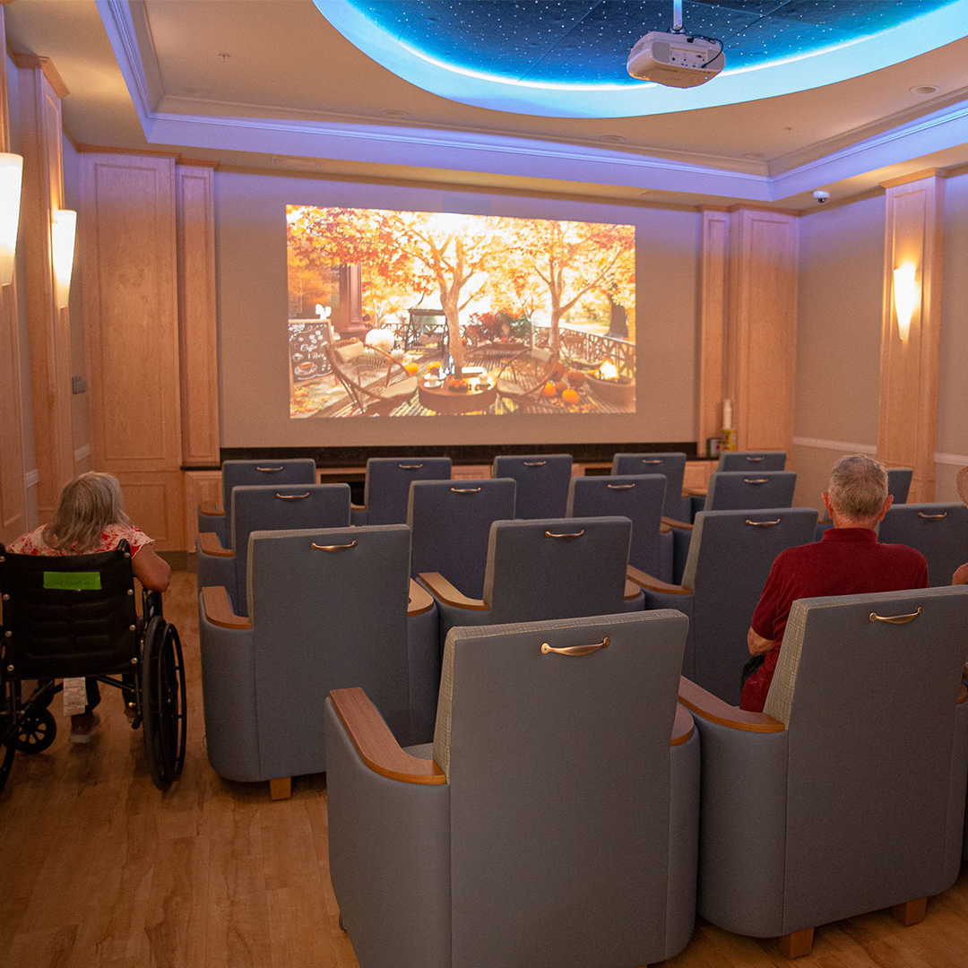 Residents enjoying a movie in a cozy theater