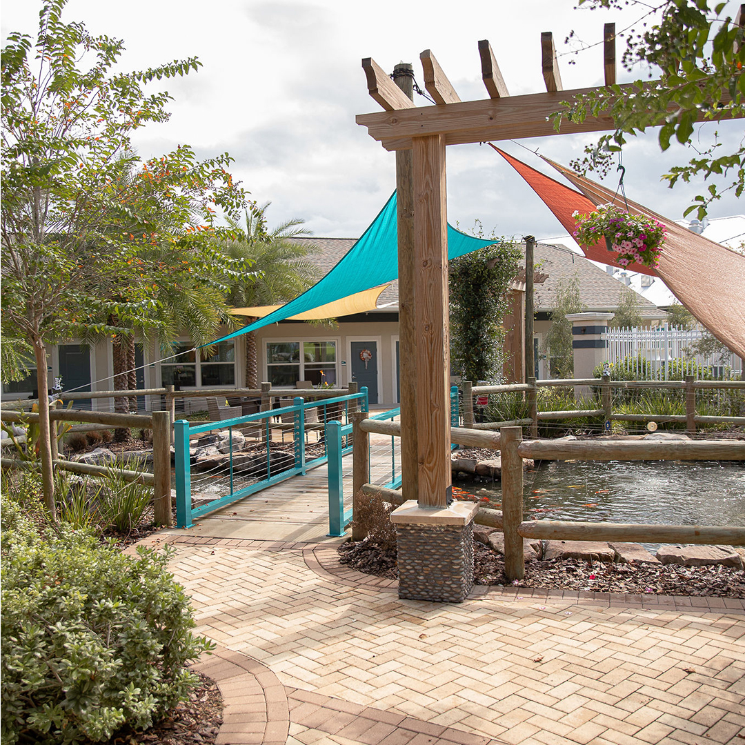 Sunny outdoor area with colorful shades and pond