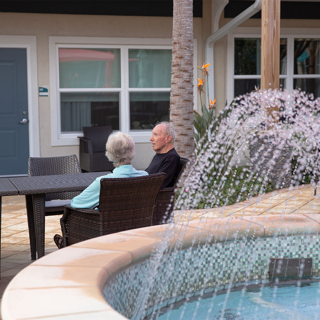 Two residents enjoying a conversation by a fountain