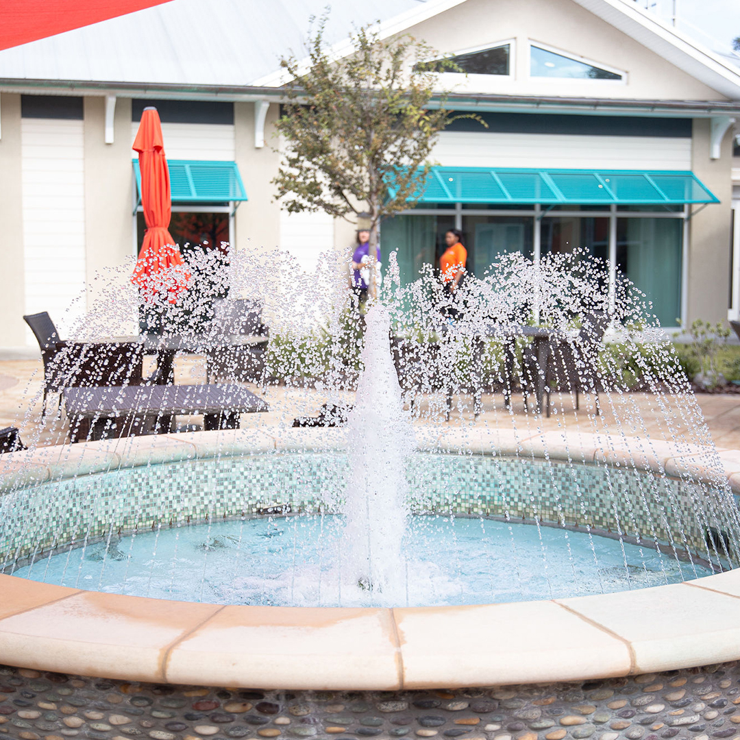 Outdoor fountain with residents in the background