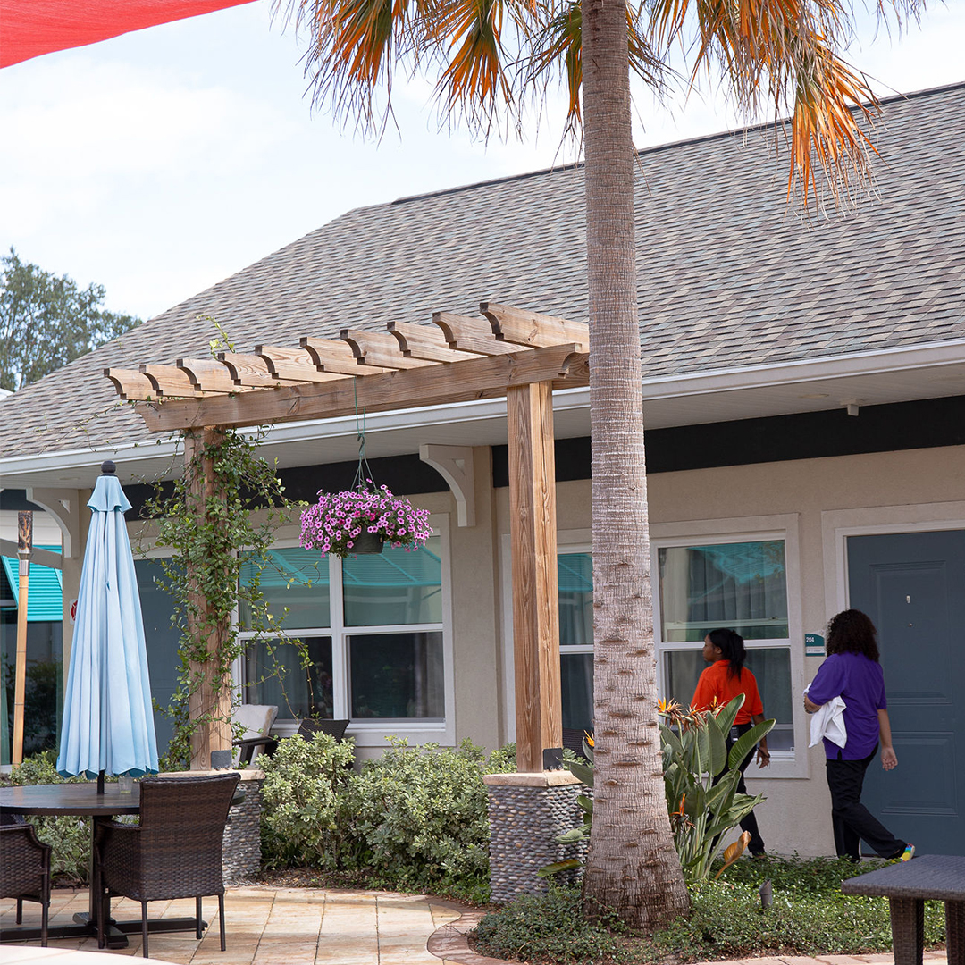 Residents walking outside a senior living facility