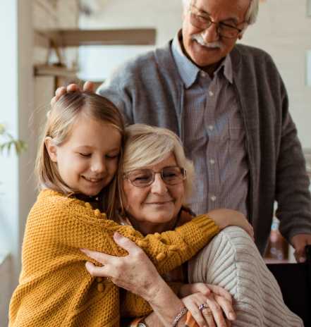 A grandparent embracing a child with joy