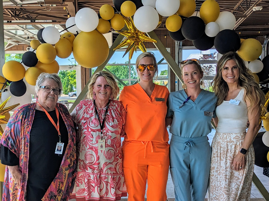 Staff members posing at a community celebration.
