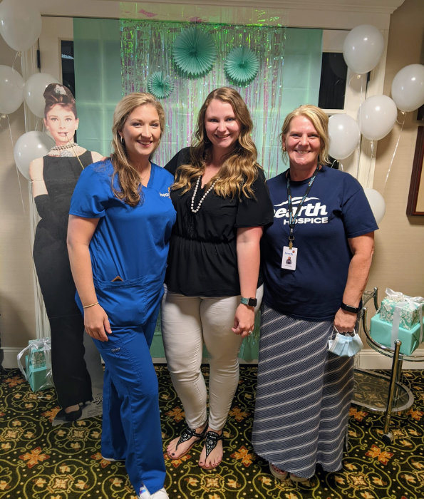Staff members celebrating with a backdrop.