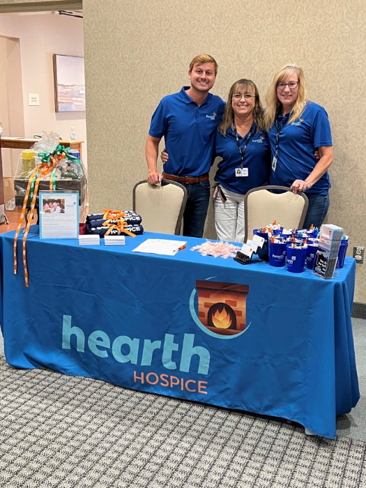 Staff members at a promotional table for Hearth Hospice.