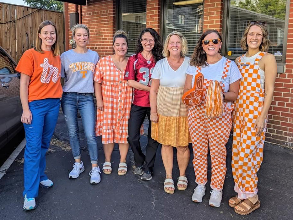 Group of staff members in themed outfits.