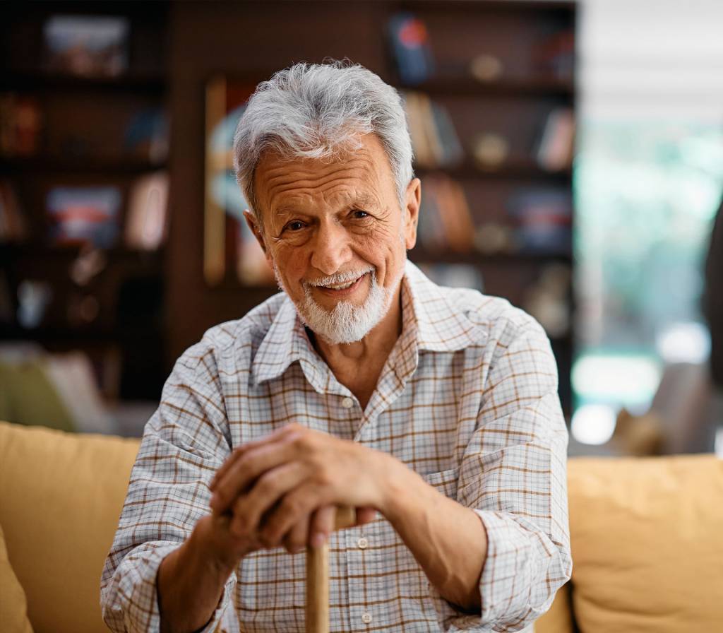 Smiling elderly man sitting on a couch
