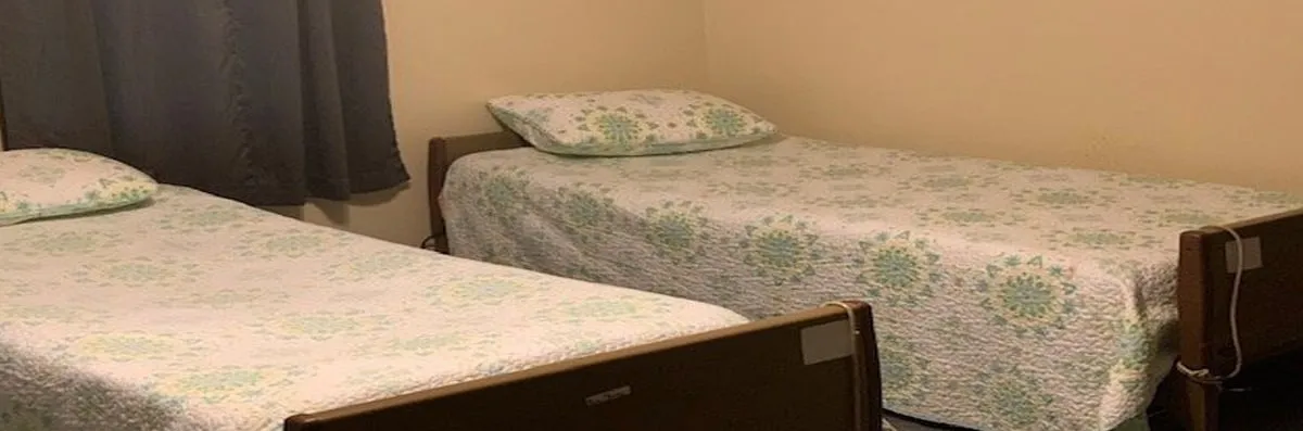 Two twin beds in a modest room setting