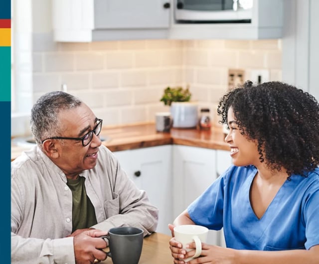 A joyful interaction between an elderly man and caregiver