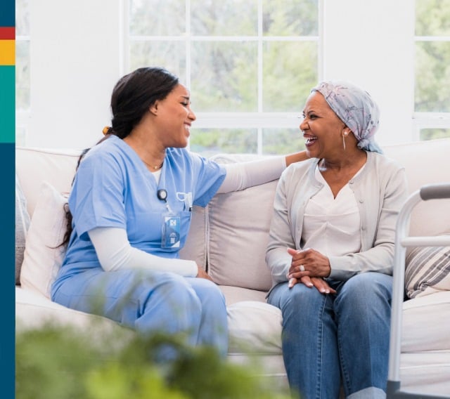 Staff member engaging with a resident on a couch
