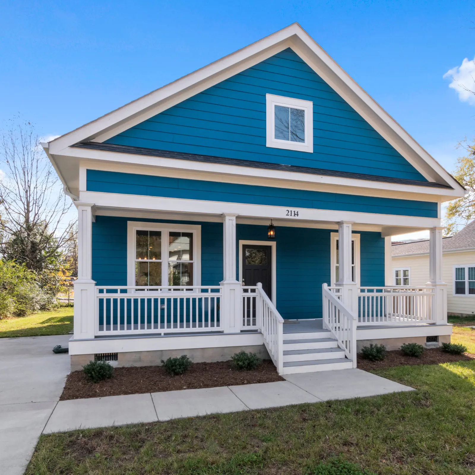 Exterior view of a blue assisted living house.