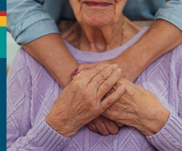 Close-up of an elderly woman being embraced