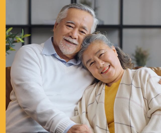 Happy older couple sitting together in a cozy setting.
