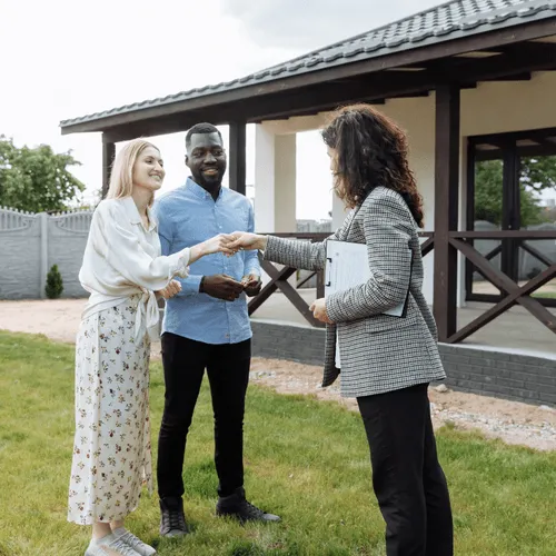 Two people shaking hands outside the facility