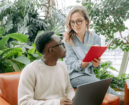 Two individuals engaged in conversation in a common area.