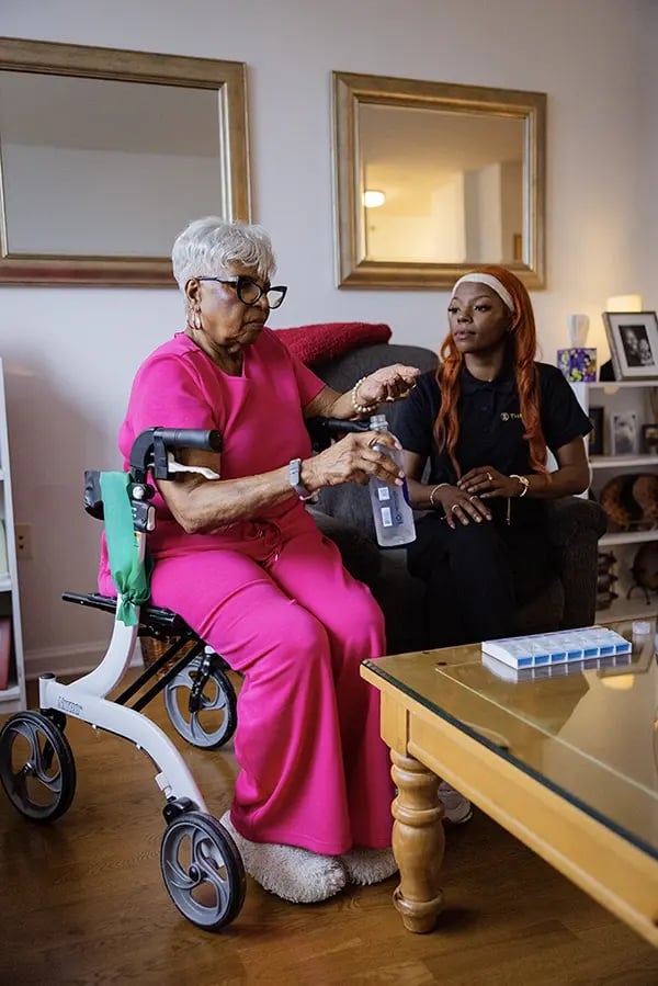 Resident and staff member engaging indoors.