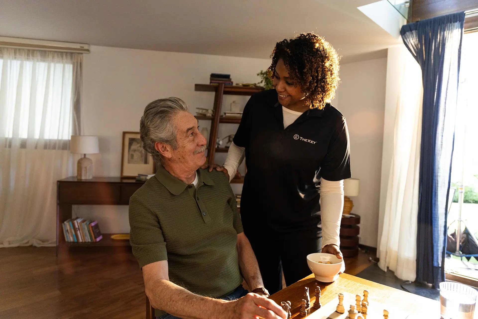 Resident and staff member enjoying a game of chess.