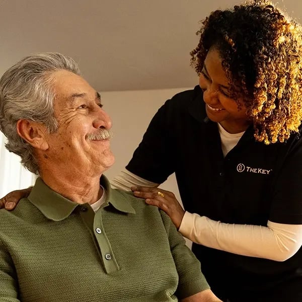 Caregiver interacting warmly with an elderly resident.