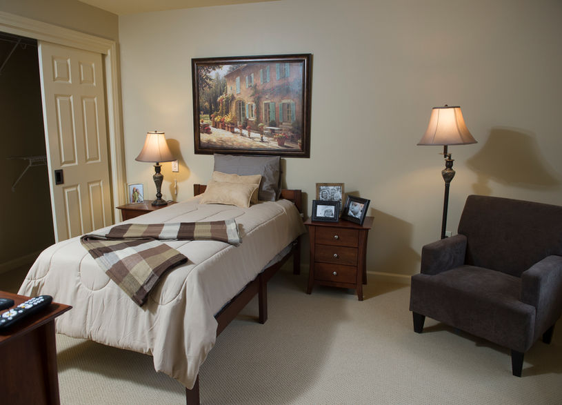 Cozy resident room with a bed and artwork
