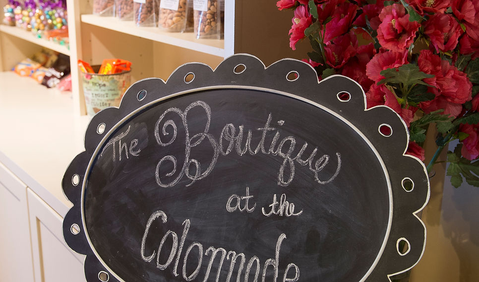 Chalkboard sign for The Boutique at the Colonnade