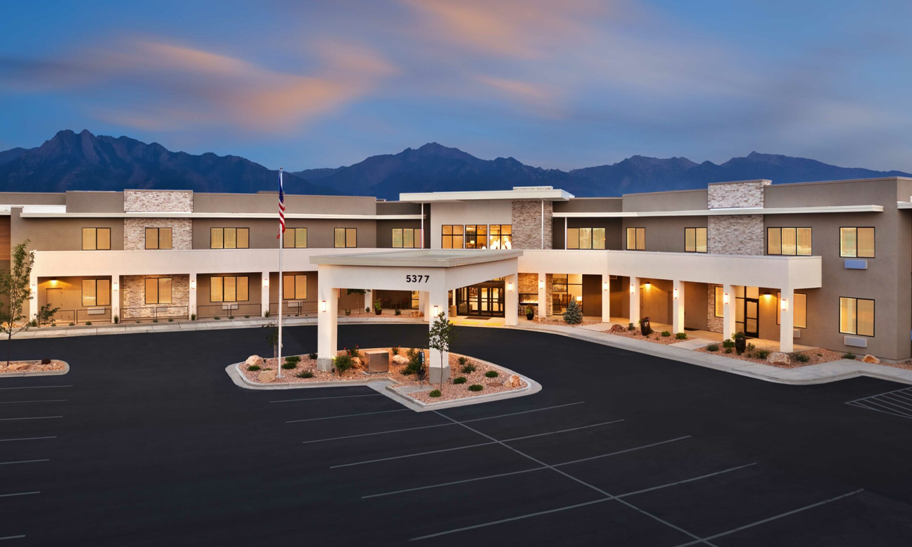 Exterior view of Abbington Senior Living facility at dusk