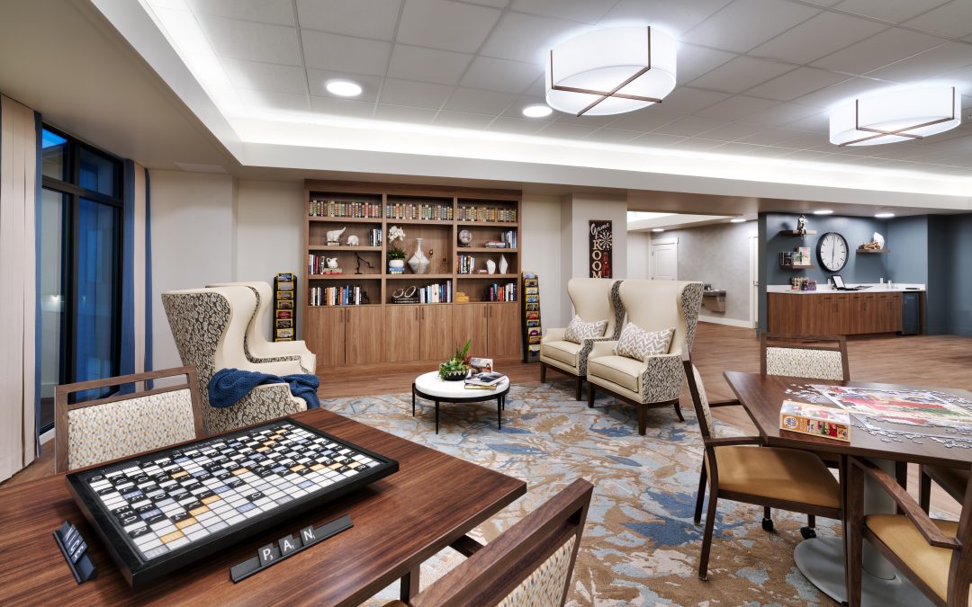 Bright interior common area with seating and bookshelves