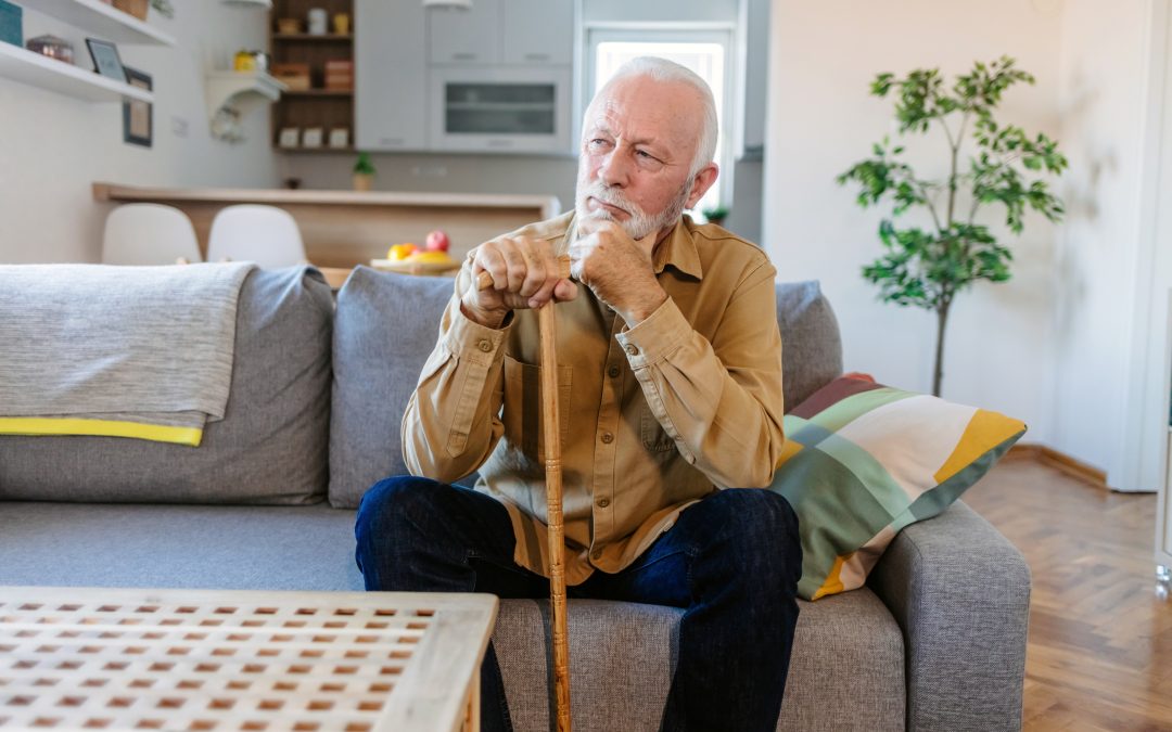 Senior man sitting thoughtfully on a couch