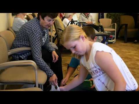 Children engaging with residents in a lounge area