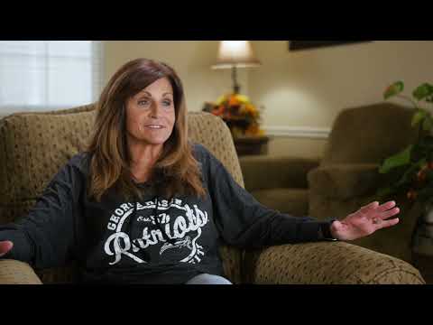 Resident sharing her experience in a cozy lounge area
