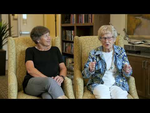 Two residents sitting in a common area engaging in conversation.