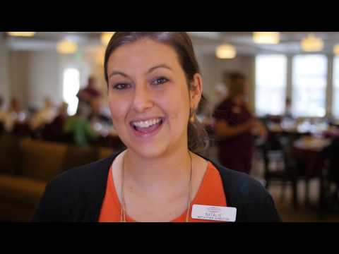 Staff member smiling in a common area