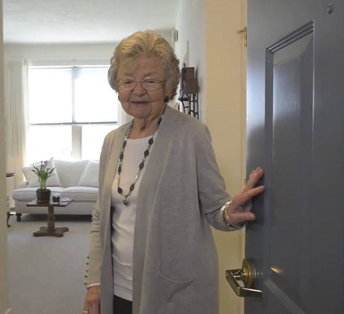Resident greeting at the entrance of her apartment