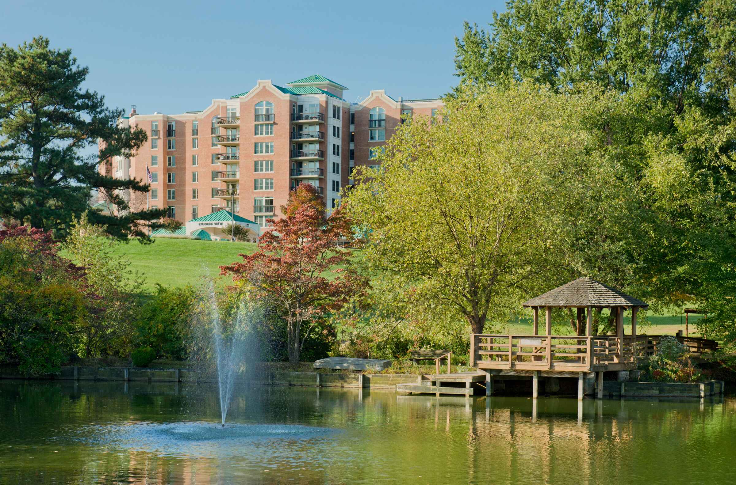 Outdoor view of a building with a pond and gazebo
