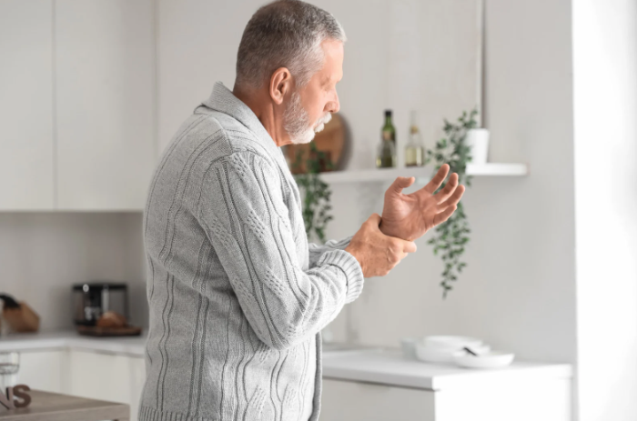 Older man enjoying a moment in a bright kitchen