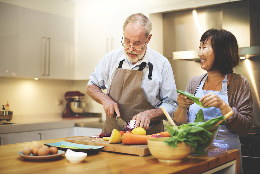 Residents enjoying cooking together in a kitchen