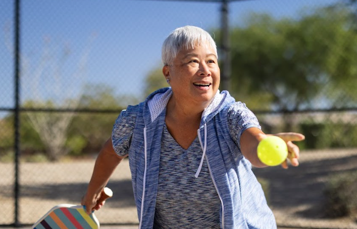 Resident enjoying an outdoor pickleball game
