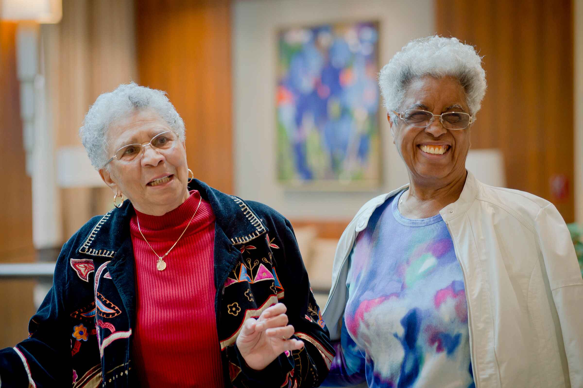 Two smiling residents in a common area