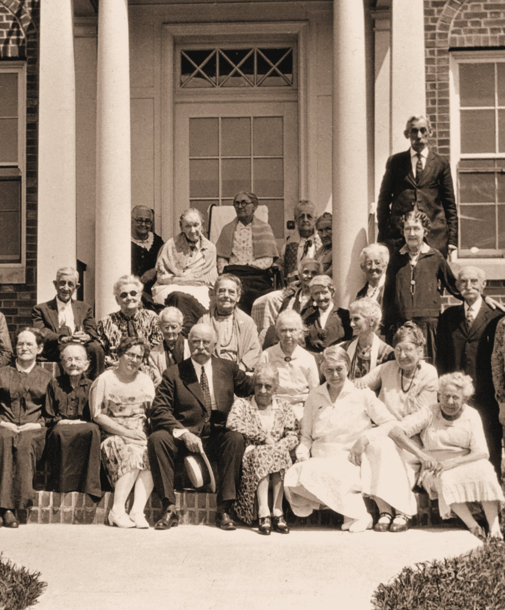 Group of residents and staff posing outside the facility