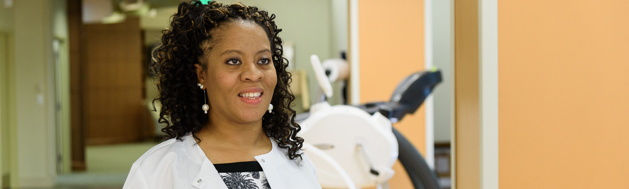 Staff member smiling in a facility interior