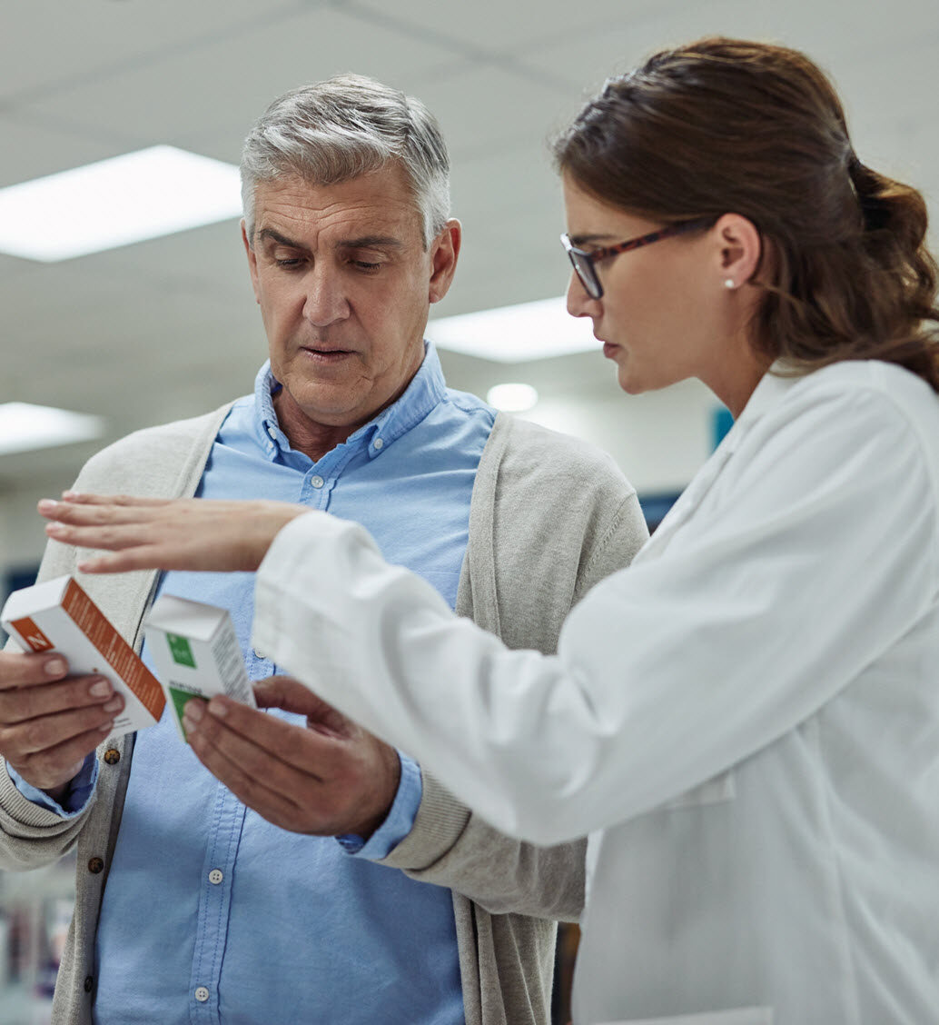 A healthcare professional consulting with a resident about medications