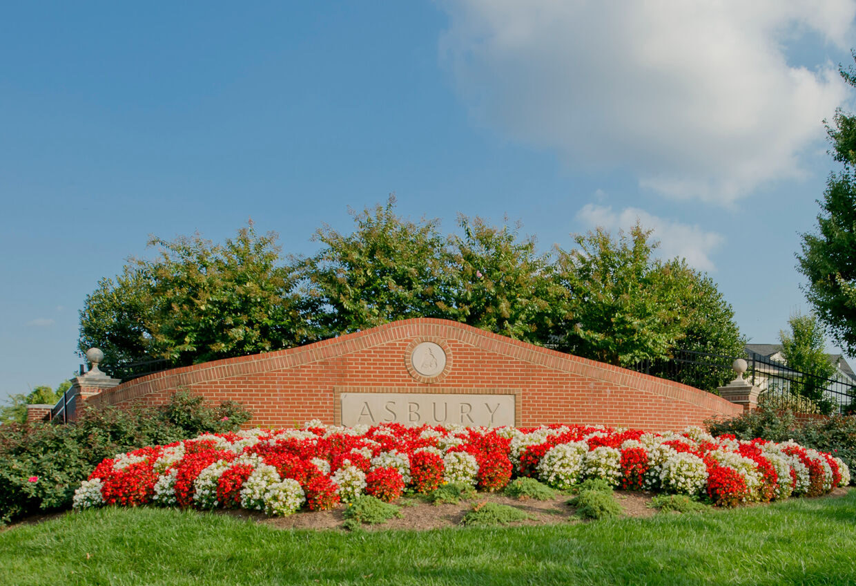 Welcoming outdoor sign with colorful flowers at Asbury