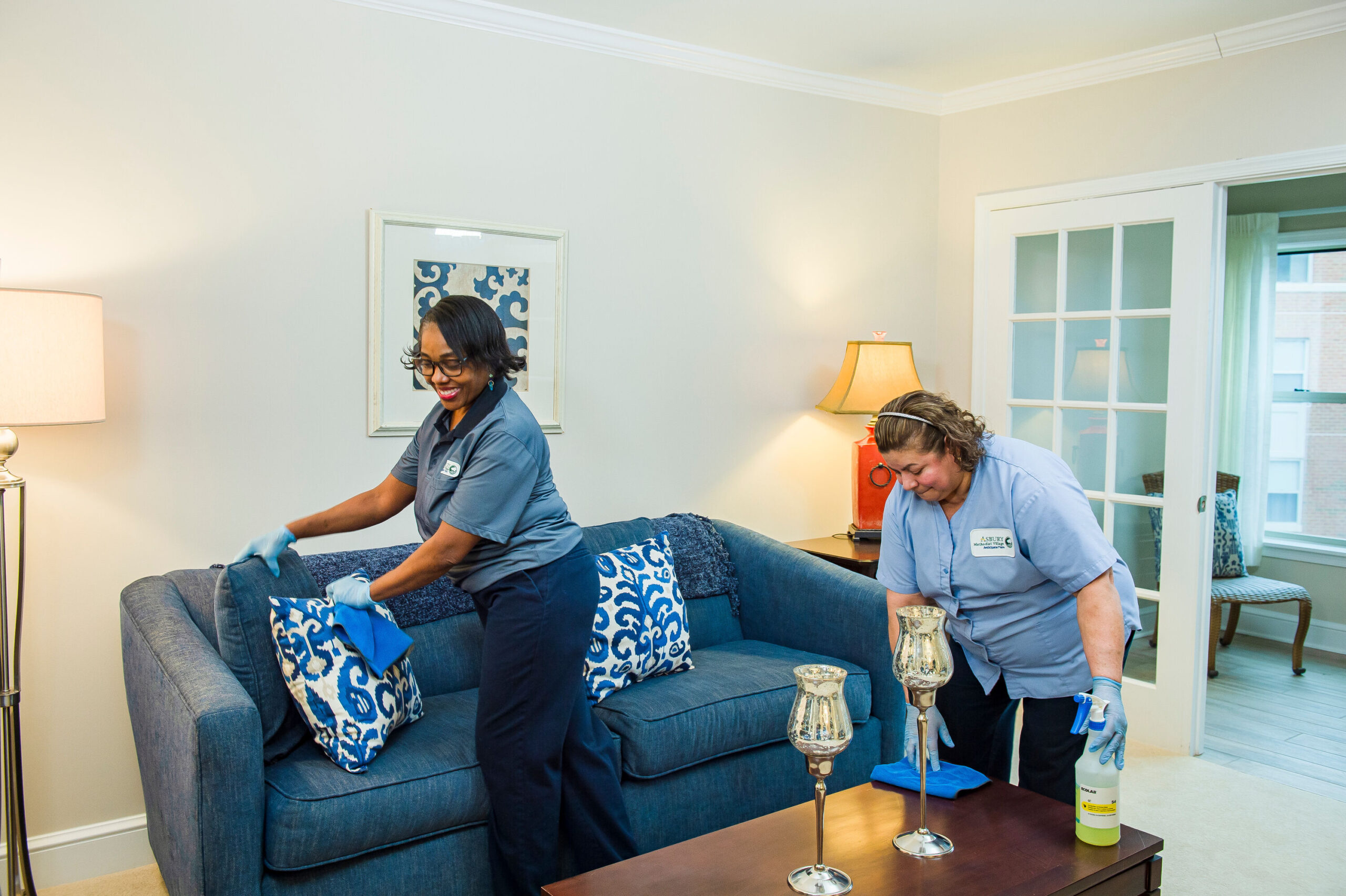 Staff cleaning a resident's living area
