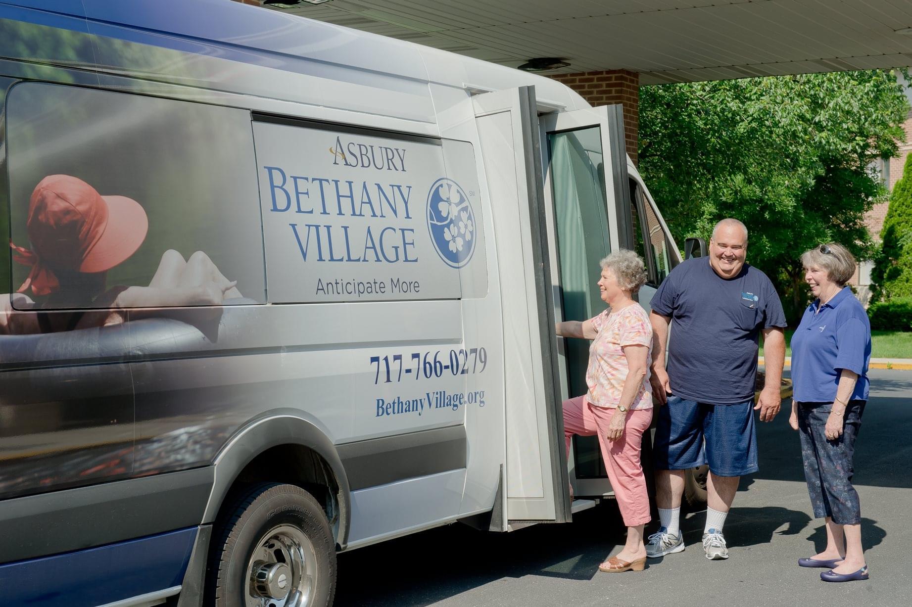 Residents being assisted with facility transport van